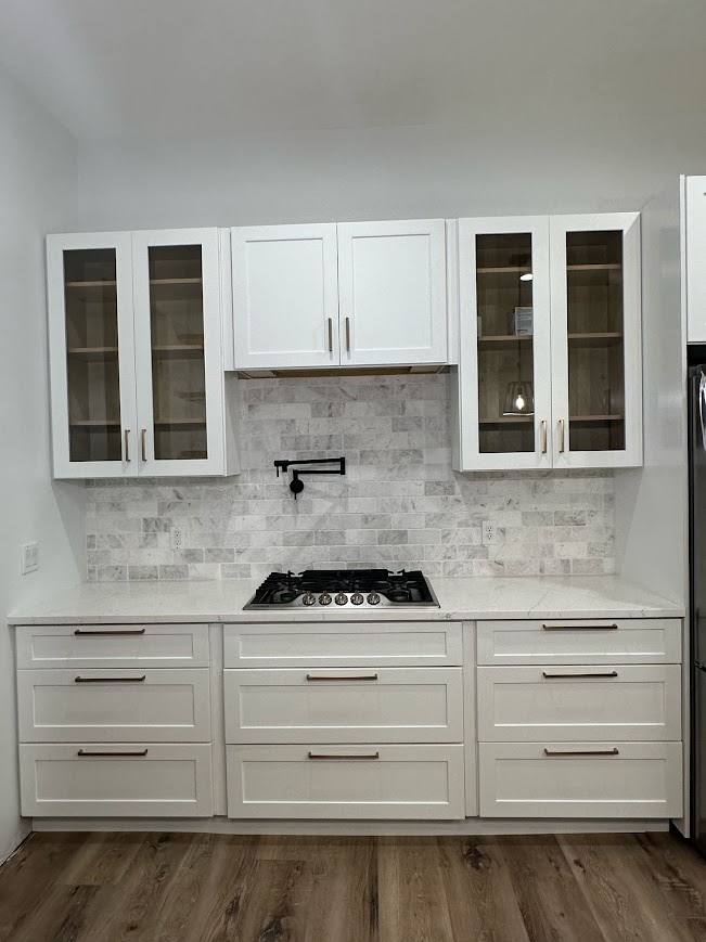 Georgetown, TX kitchen after remodel — white shaker cabinets, marble backsplash, pot filler