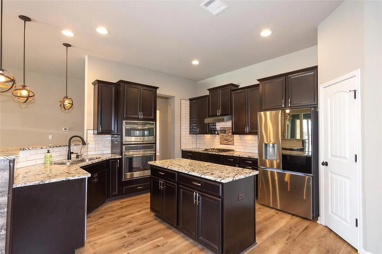 Georgetown, TX kitchen before remodel — brown cabinets and gold hardware