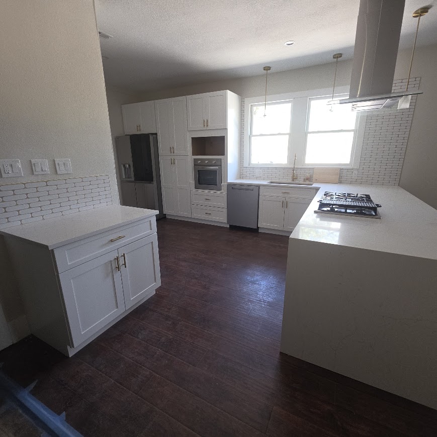 Vintage Central Texas kitchen after remodel — white quartz counters and subway tile backsplash