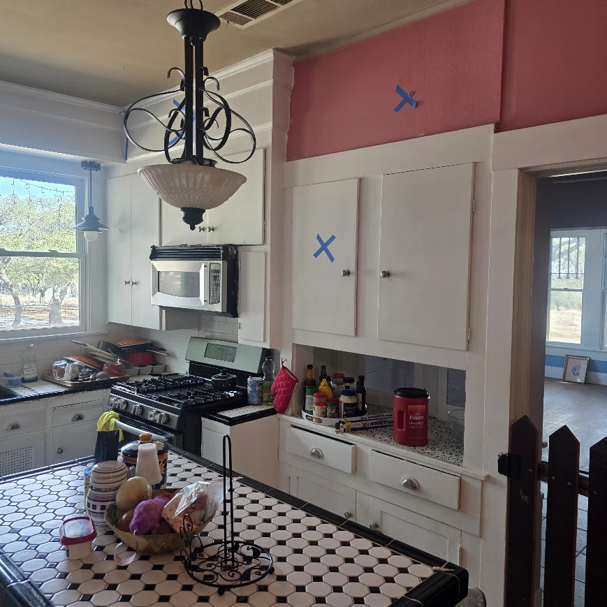 Vintage Central Texas kitchen before remodel — original 1940s cabinets and tile counters