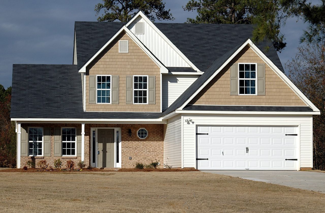Example of a well-maintained painted exterior with siding, brick and trim